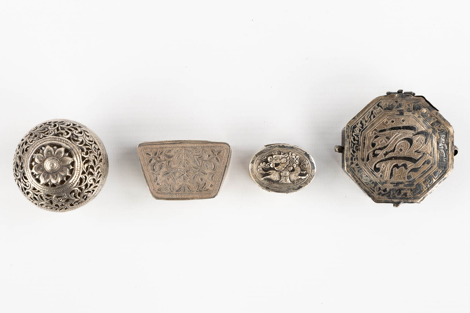 Fourteen Islamic and Indian Amulet or Trinklet boxes, Silver and silver-plate. 19th/20th C. (L:9,5 x W:16,5 x H:2,5 cm)