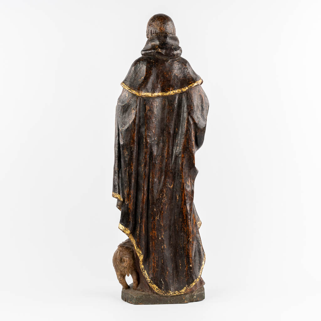 An antique wood-sculptured figurine of Saint Anthony the Great, with a pig. 18th C.