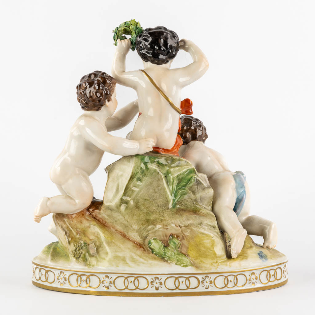 Volkstedt, Rudolstadt, a polychrome porcelain group with putti. (L:12,5 x W:23,5 x H:24 cm)