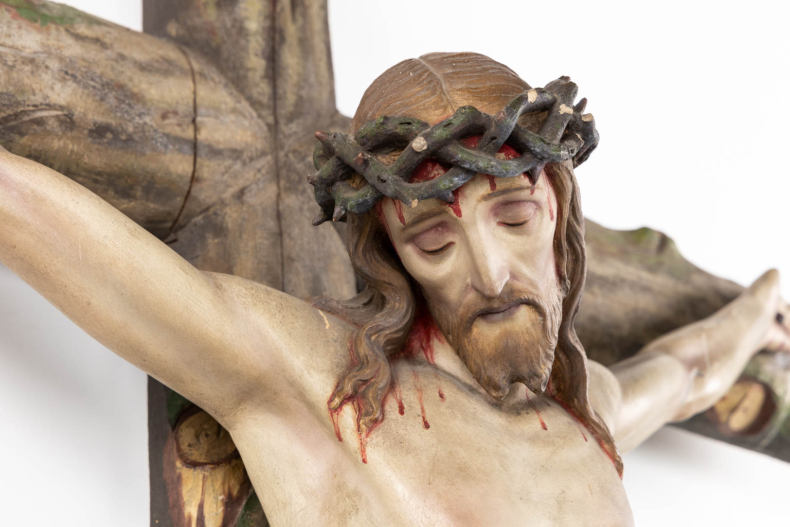 A large Corpus Christi, mounted on a faux tree crucifix, polychrome plaster. (W:130 x H:250 cm)