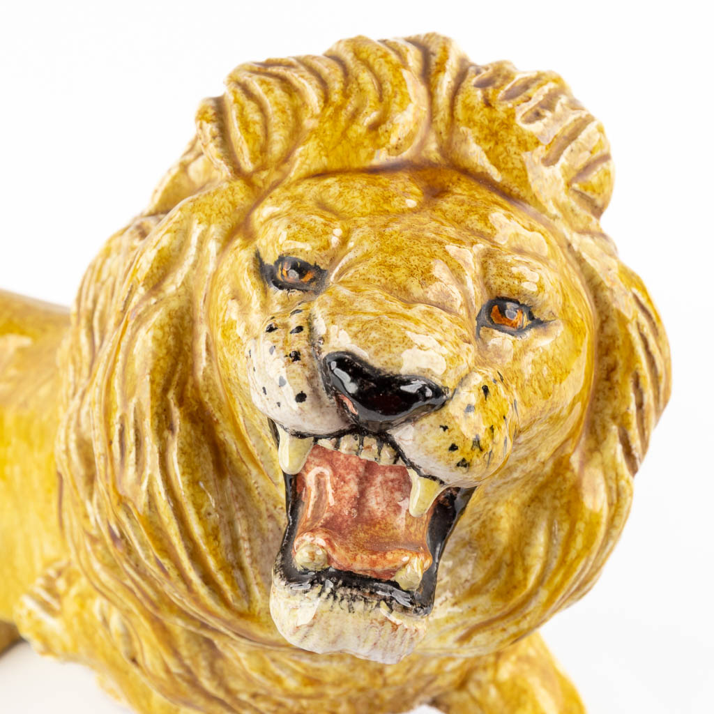 A decorative lying lion, glazed terracotta. Italy, circa 1960-1970. 