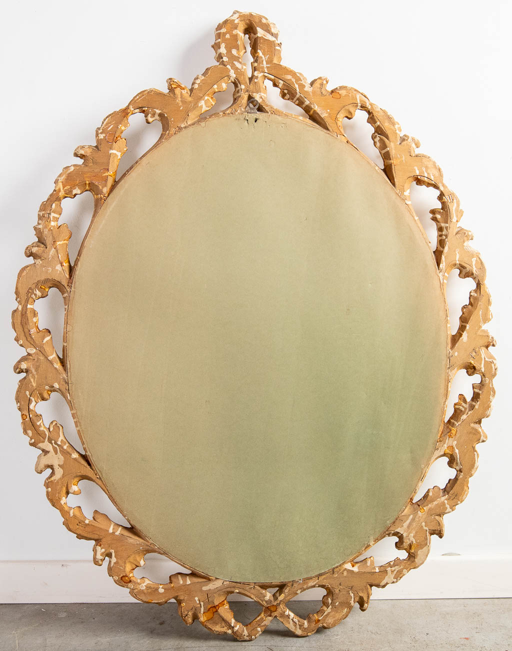 A wood-sculptured oval mirror, circa 1960. (W:73 x H:94 cm)