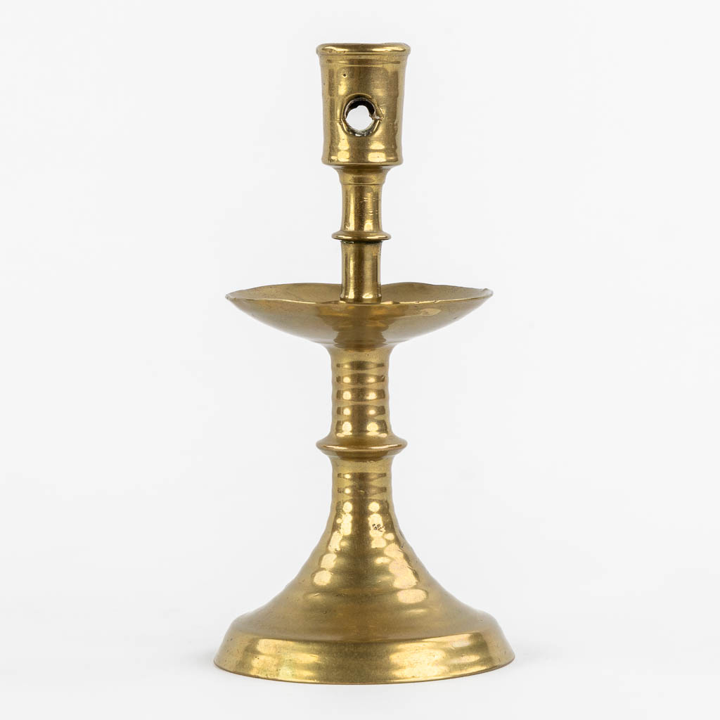 A brass disk candlestick, so-called 