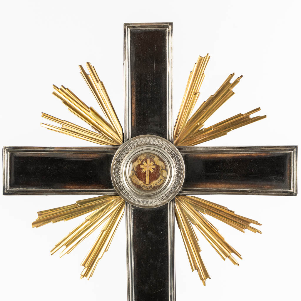 A crucifix with sunburst rays, mounted with a sealed theca and a relic of the True Cross. 19th C. (L:9 x W:21 x H:49,5 cm)