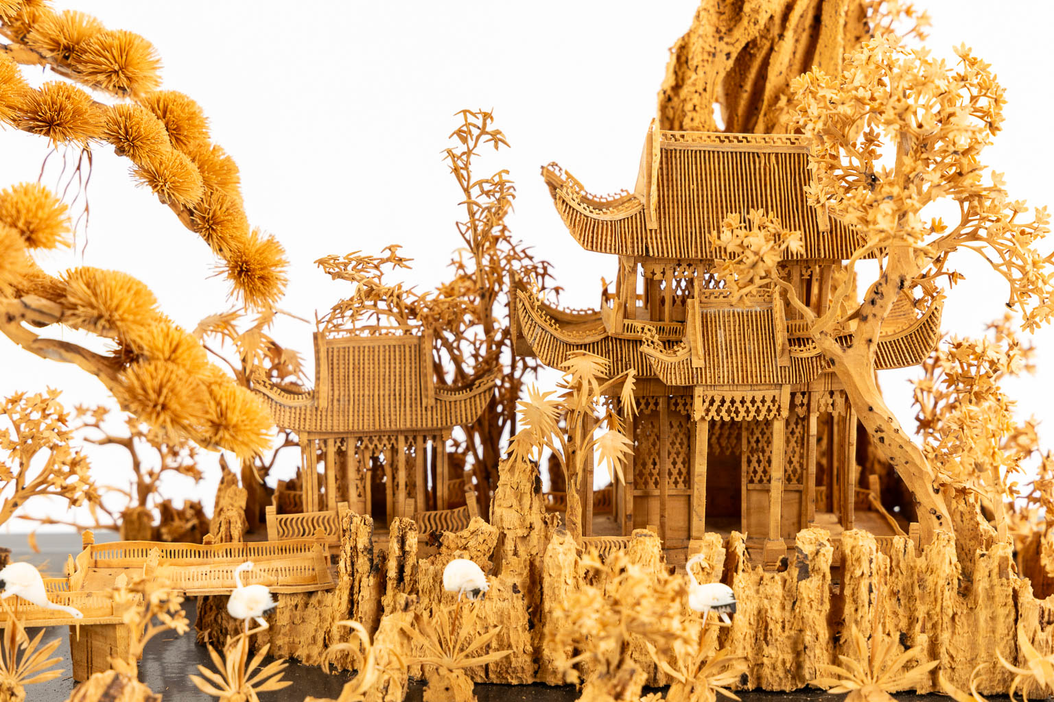 A Japanese cork diorama of a garden, in a glass display cabinet. 20th C. (L:25 x W:55 x H:36 cm)