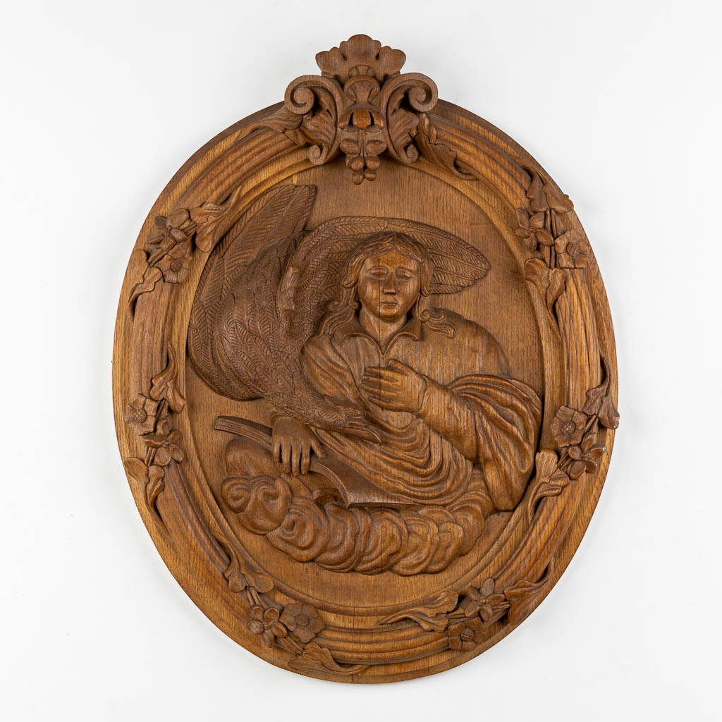 A set of four big oval wood sculptures depicitng 