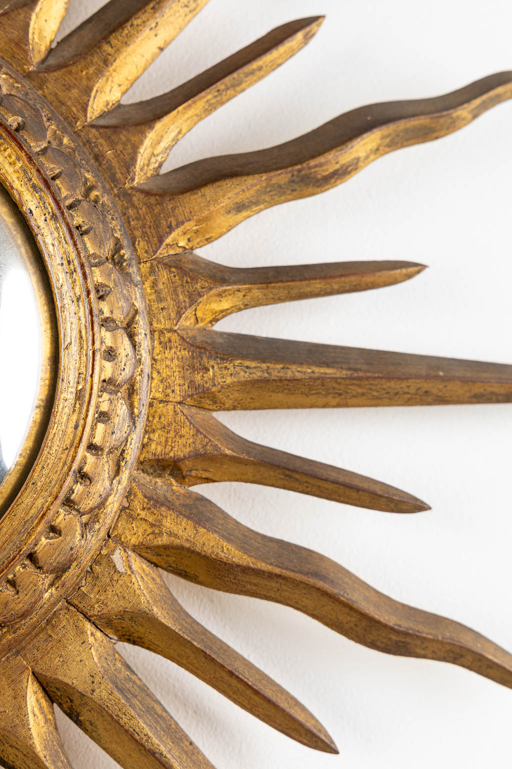 A sunburst mirror, gilt and sculptured wood. (D:66 cm)