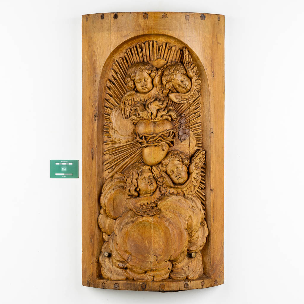 A wood-sculptured tabernacle door, Angels and a Sacred Heart, Baroque style. 