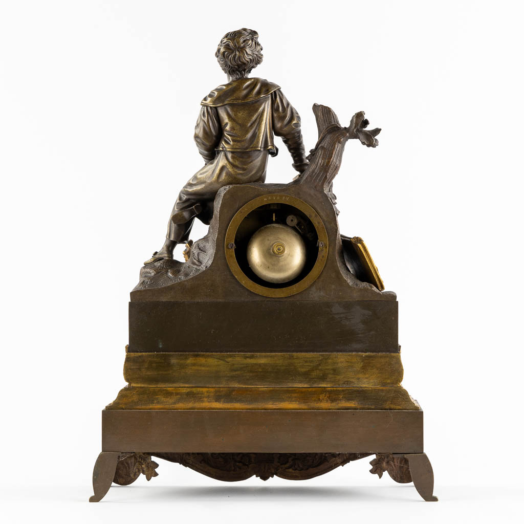 Een schouwklok, verguld en gepatineerd brons, Empire stijl. 19de eeuw. (L:13 x W:34 x H:46 cm)