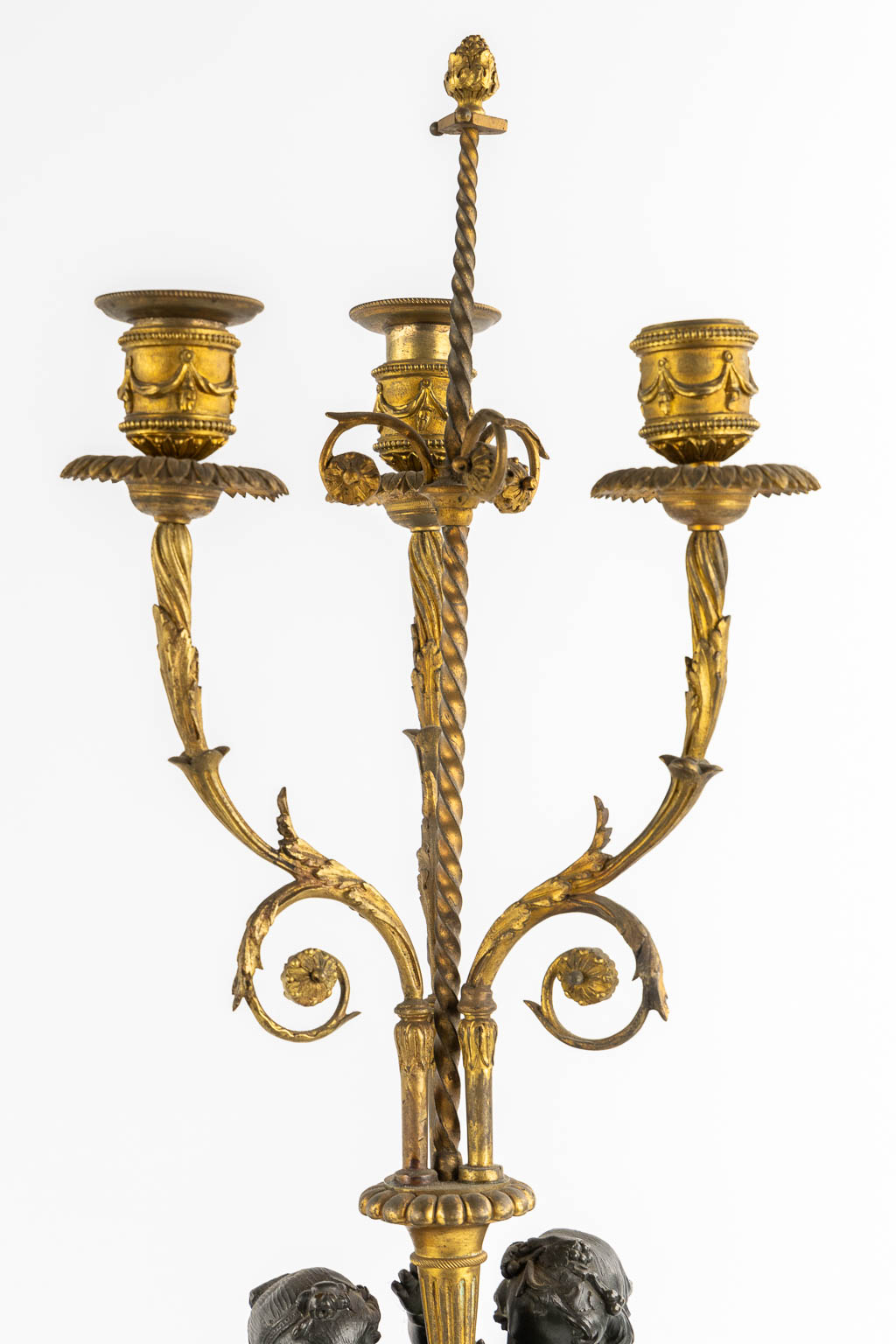 A pair of Marble, gilt and patinated bronze candelabra with putti, Louis XVI style, 19th C. (L:16,5 x W:16,5 x H:71,5 cm)