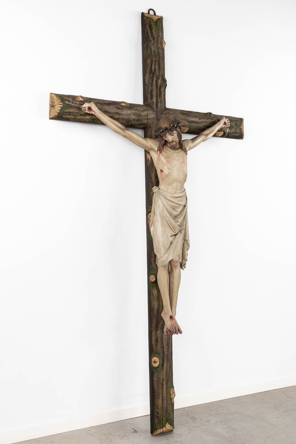 A large Corpus Christi, mounted on a faux tree crucifix, polychrome plaster. (W:130 x H:250 cm)