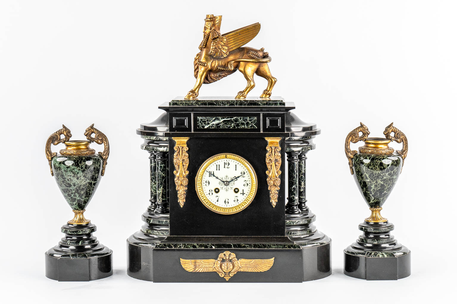 A Neoclassical three-piece mantle garniture clock and side pieces, marble and bronze. 19th C.