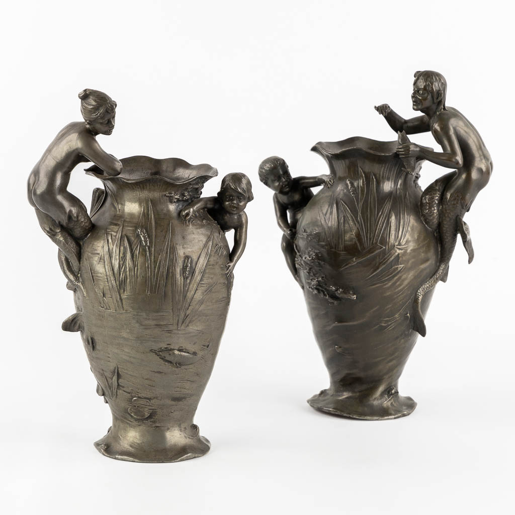 WMF, a pair of vases with playing children, a Mermaid and a Satyr, Art Nouveau, circa 1900. (L:13 x W:17 x H:29,5 cm)