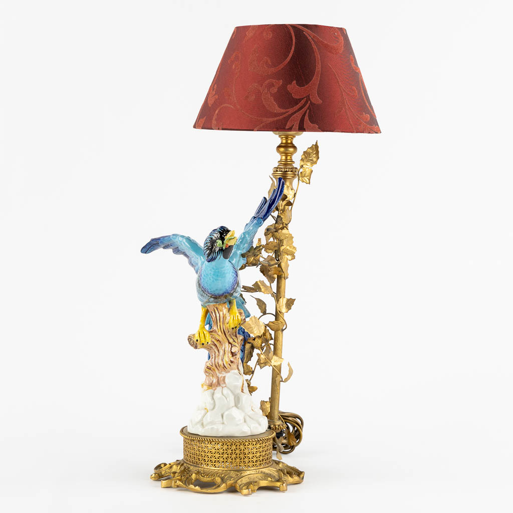 A decorative table lamp, brass mounted with polychrome porcelain. (L:16 x W:18 x H:45 cm)