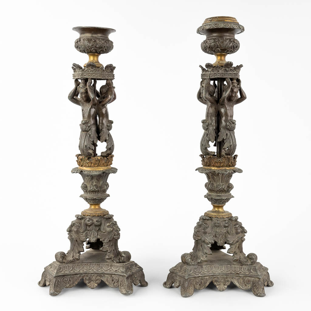 A pair of candlesticks decorated with Karyatids. Spelter and bronze. 19th C. (L:17 x W:17 x H:48 cm)