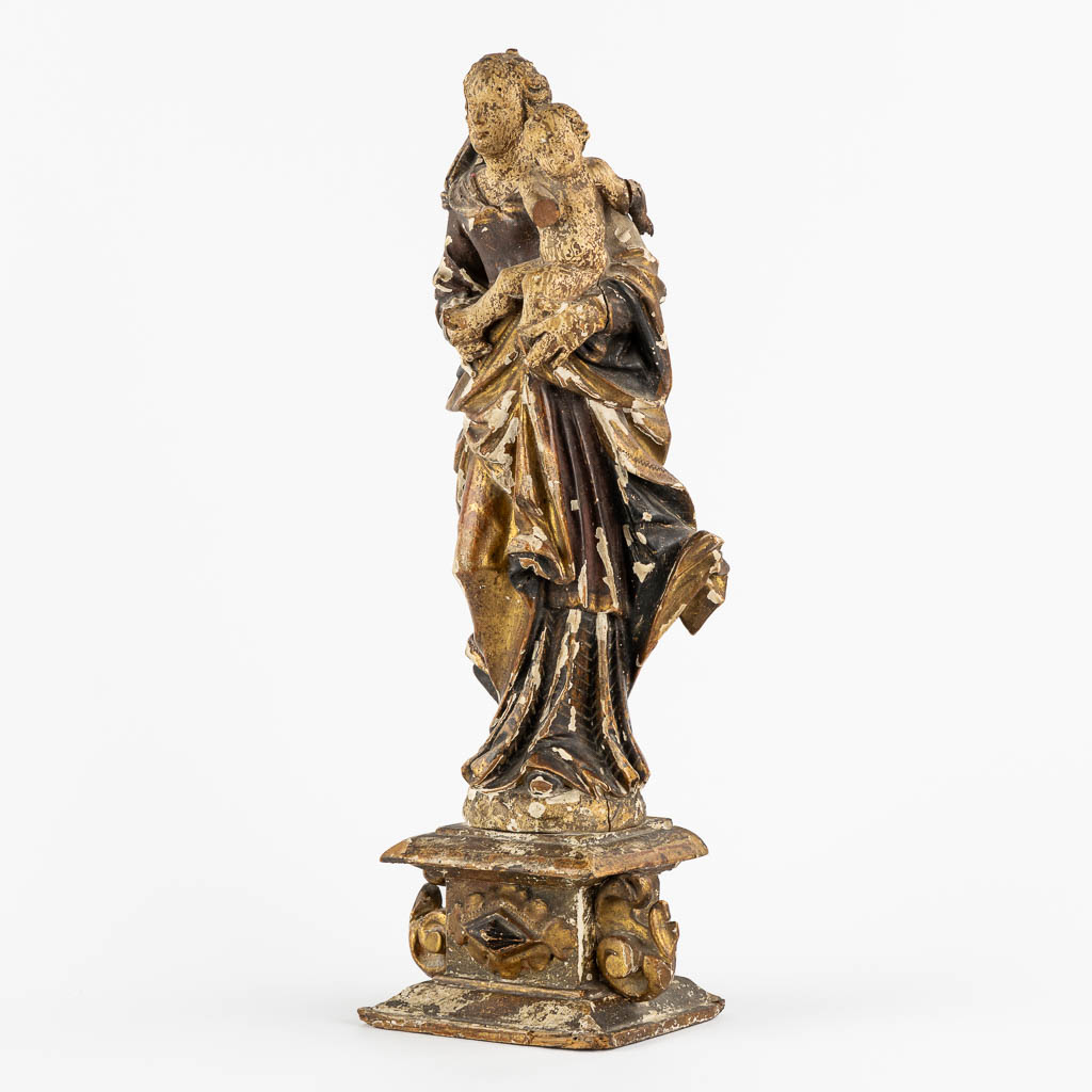 An antique wood-sculptured figurine of Madonna with a Child. 17th/18th C. (L:11,5 x W:16 x H:45 cm)