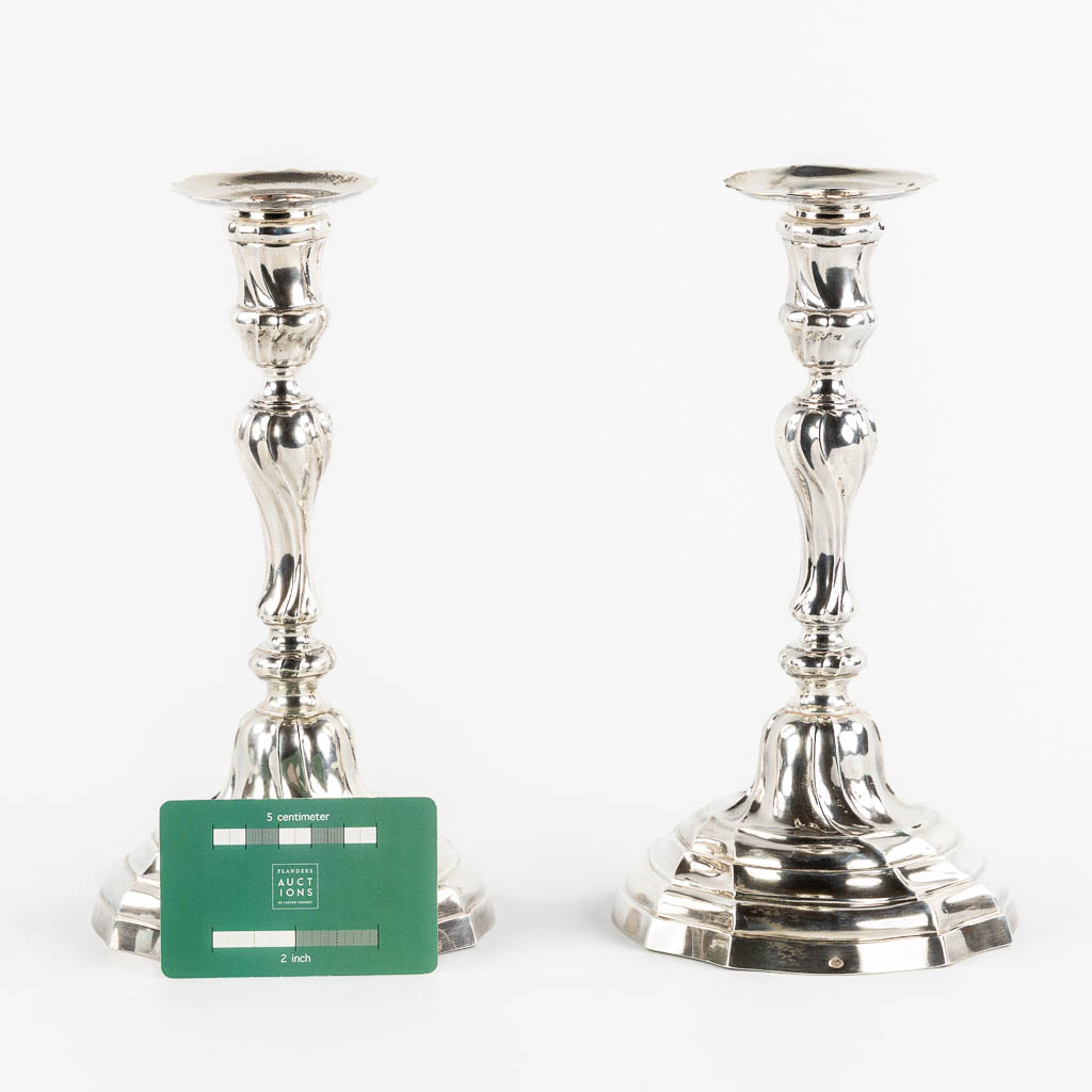 A pair of Louis XV style candlesticks, Silver, 1815-1832, after 18th C. models. 652g. 