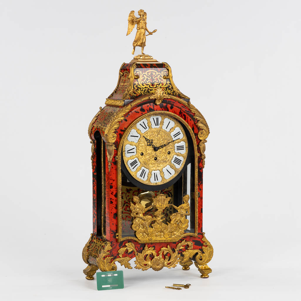 A large cartel clock, Faux Boulle in a Napoleon 3 style, mounted with gilt bronze. 20th C. (L:15 x W:40 x H:85 cm)