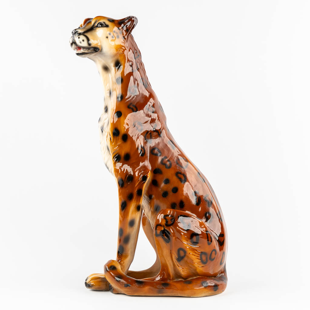 A decorative figurine of a leopard, patinated resine. 