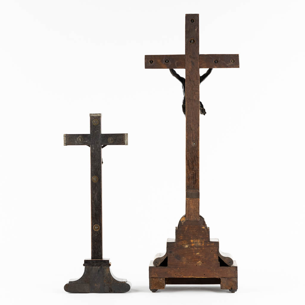 Two crucifixes with a silver Corpus Christi, 19th C. (W:24 x H:70 cm)