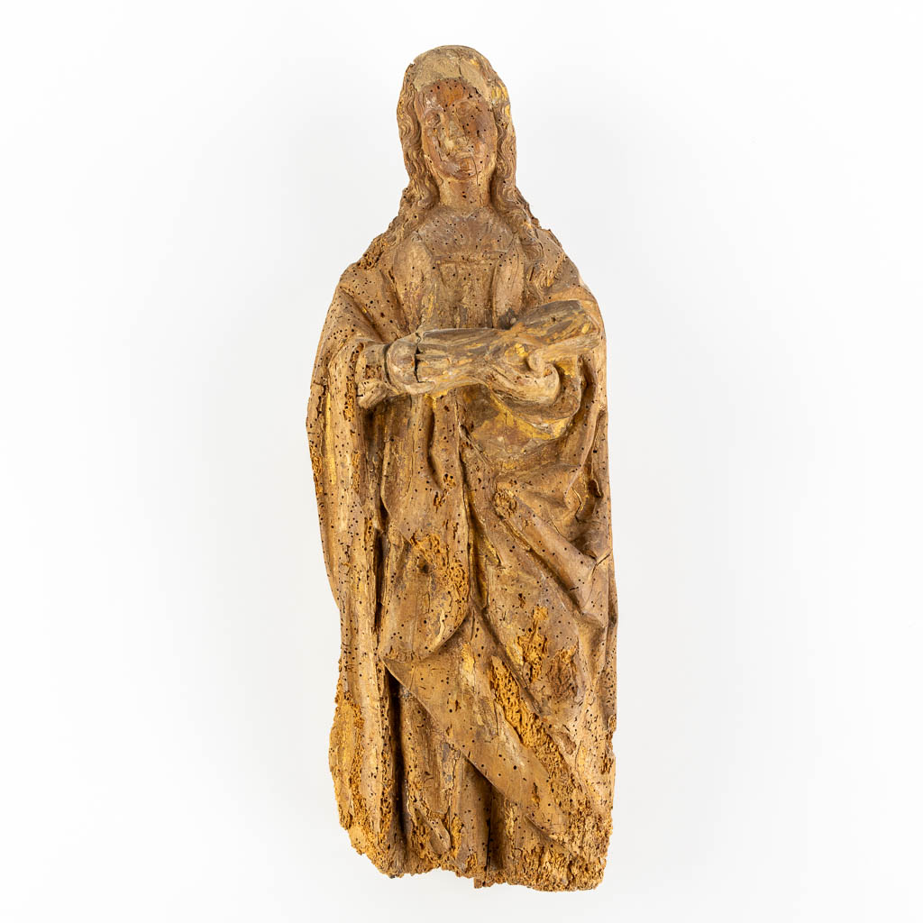 An antique wood-sculptured figurine of a saint holding a book, oak, 17th C. (L:17 x W:20 x H:53 cm)