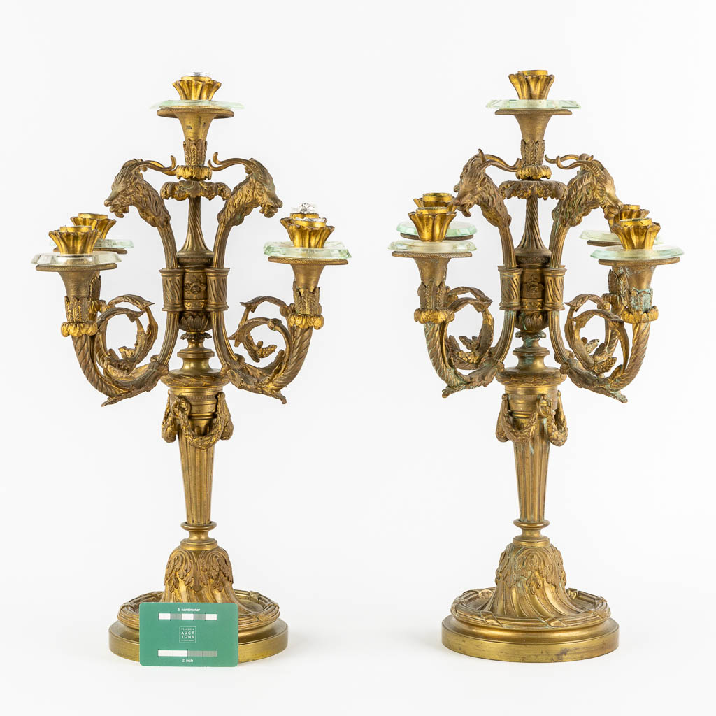 A pair of gilt bronze candelabra, mounted with crystal in a Louis XVI style. Circa 1900. (H:51 x D:34 cm)