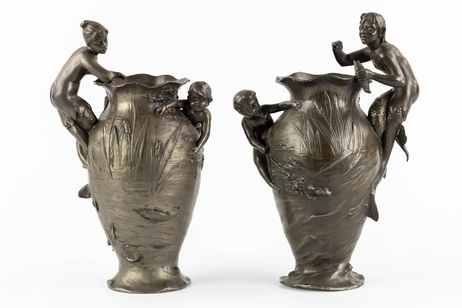 WMF, a pair of vases with playing children, a Mermaid and a Satyr, Art Nouveau, circa 1900. (L:13 x W:17 x H:29,5 cm)