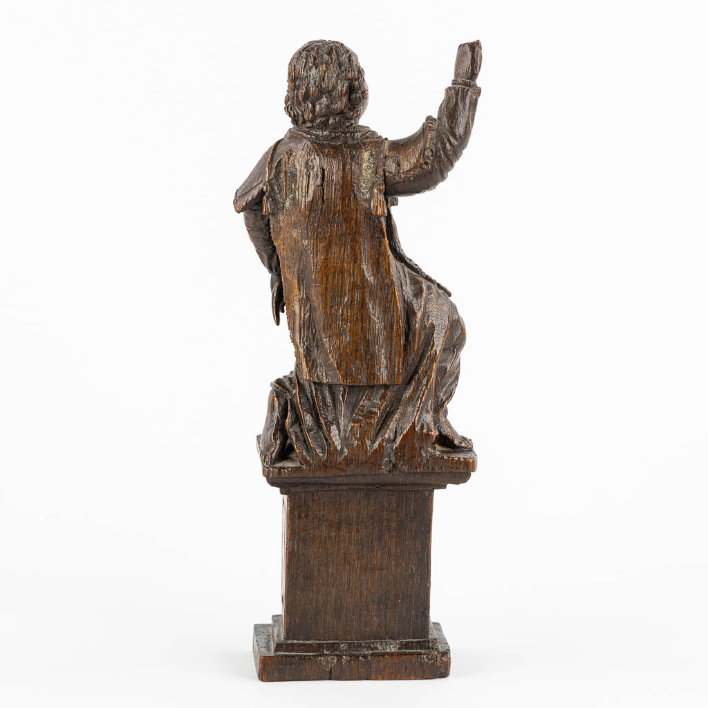 An antique wood-sculptured figurine of a saint holding a scourge. 17th C. (W:10 x H:29 cm)