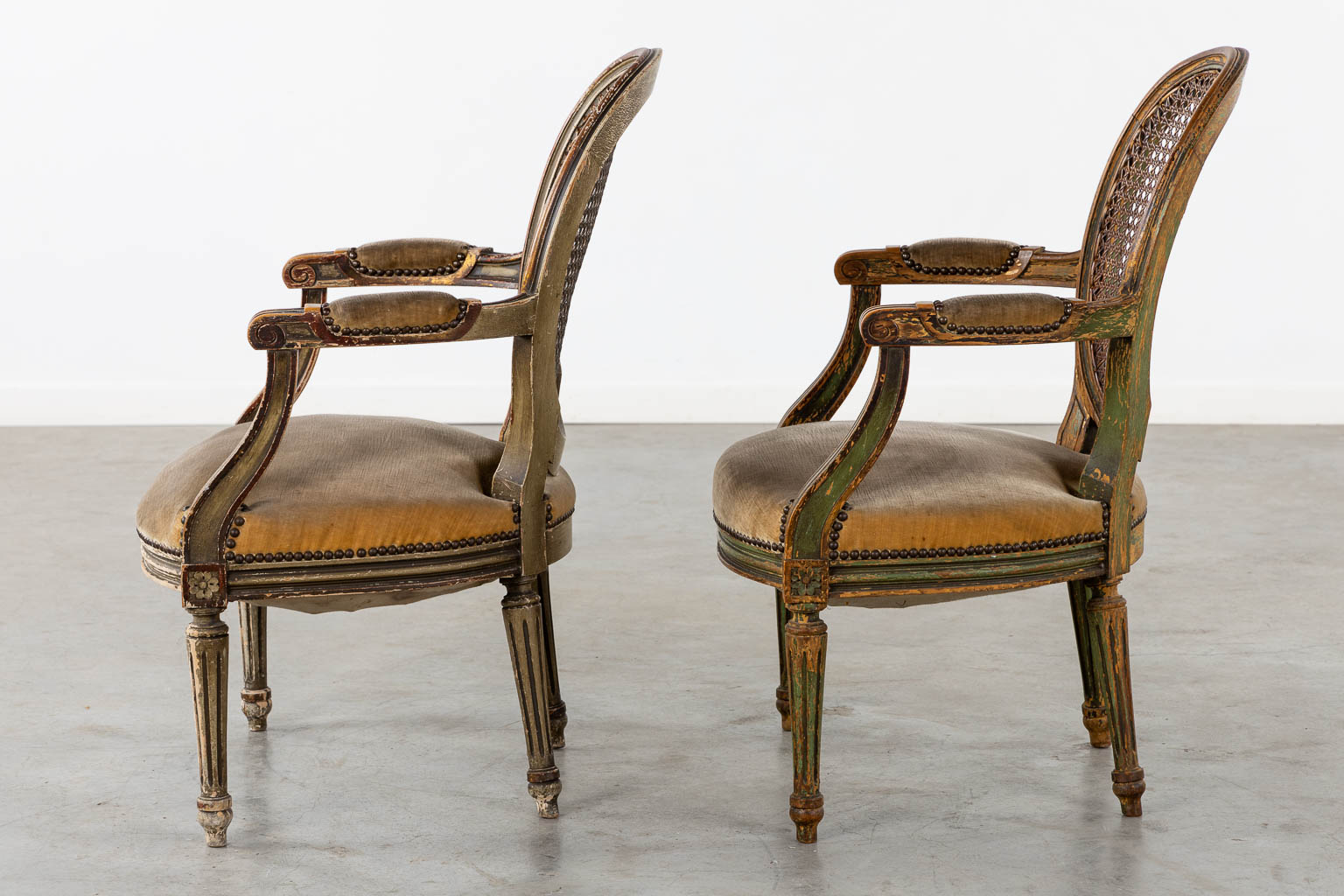 A pair of antique patinated chairs, Louis XVI style. (L:58 x W:57 x H:83 cm)