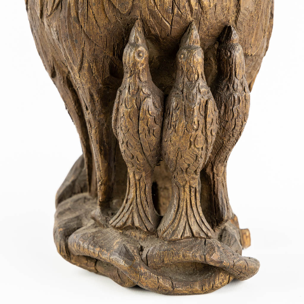 An antique wood-sculptured 'Pelican With Chicks'. 18th/19th C.