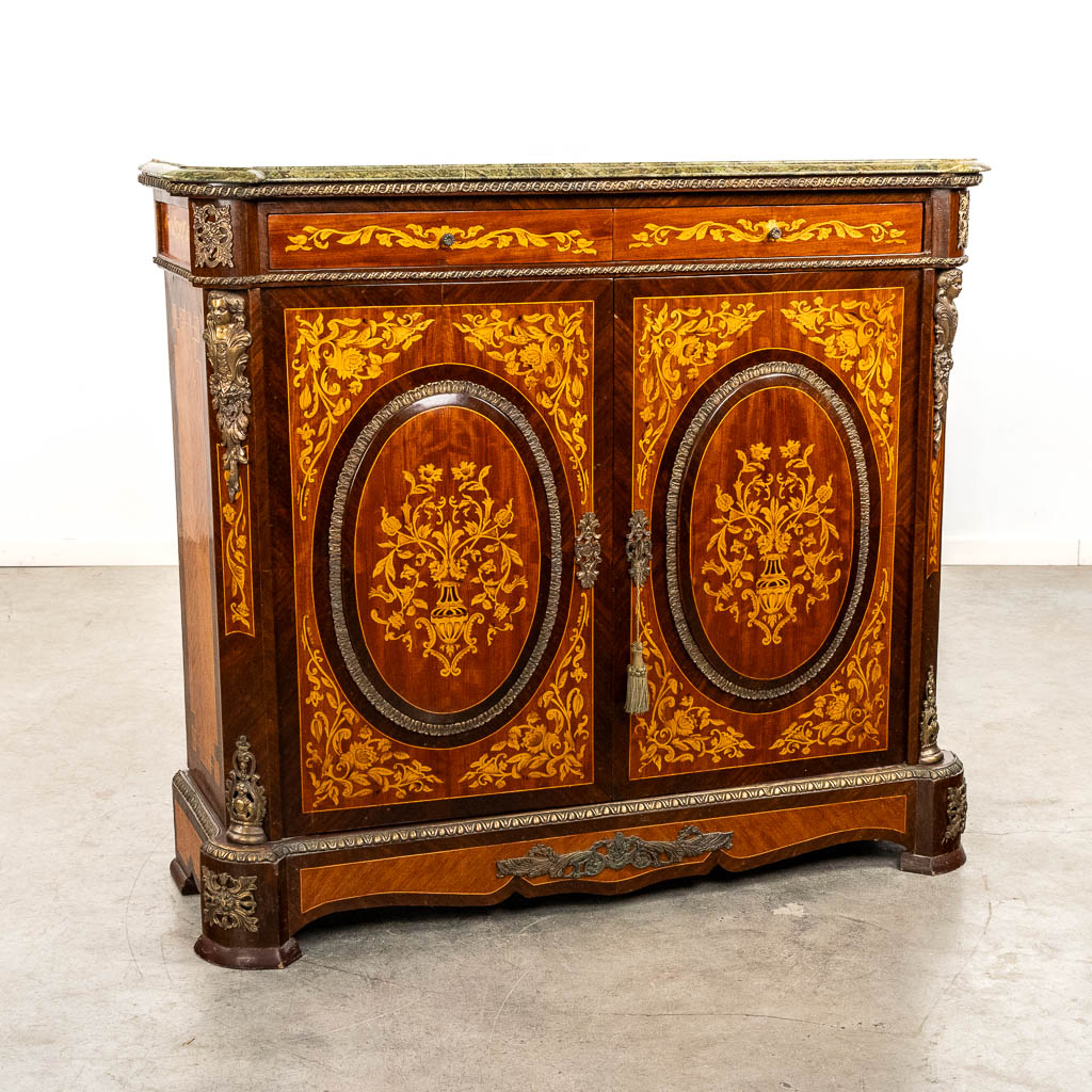 A two-door marquetry inlay cabinet, mounted with bronze and a marble. 20th C.