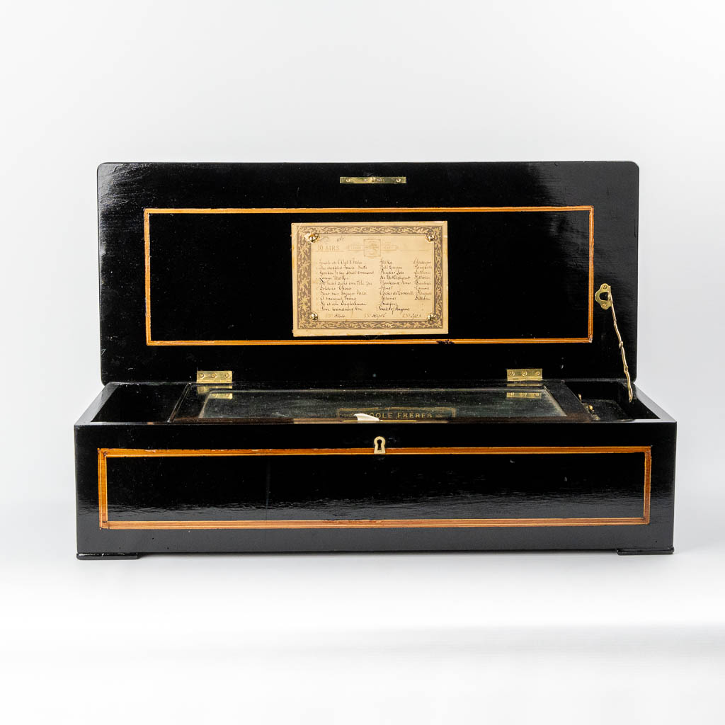 Nicole Frères, Genève and London, an antique music box in a marquetry inlay wood case. (L:30 x W:70 x H:18 cm)