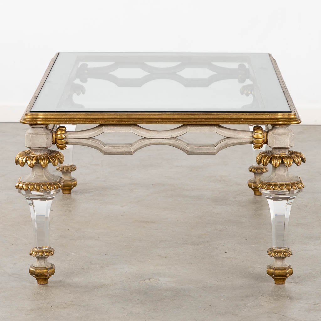 A Hollywood-Regency style coffee table, sculptured wood and plexiglass. (L:73 x W:120 x H:45 cm)