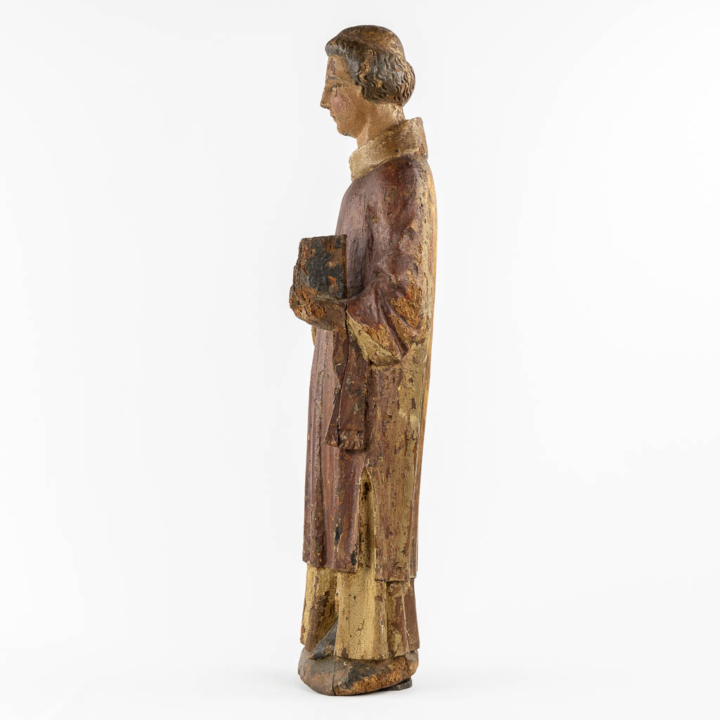 Saint Laurentius, Deacon. A wood-sculpture, oak, 14th C.  (L:20 x W:25,5 x H:90 cm)