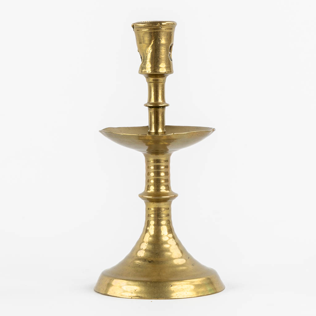 A brass disk candlestick, so-called 