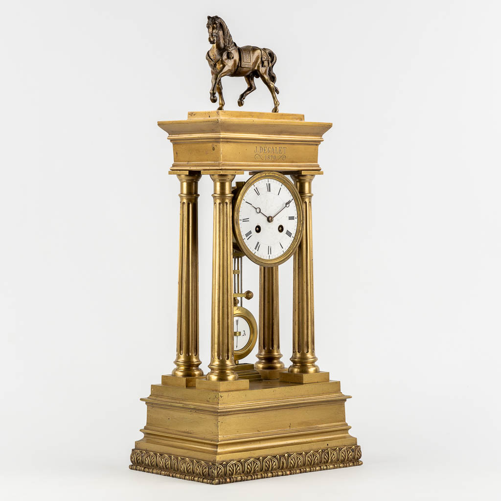 An antique column clock, bronze with a horse figurine. 19th C. (L:18 x W:27 x H:62 cm)