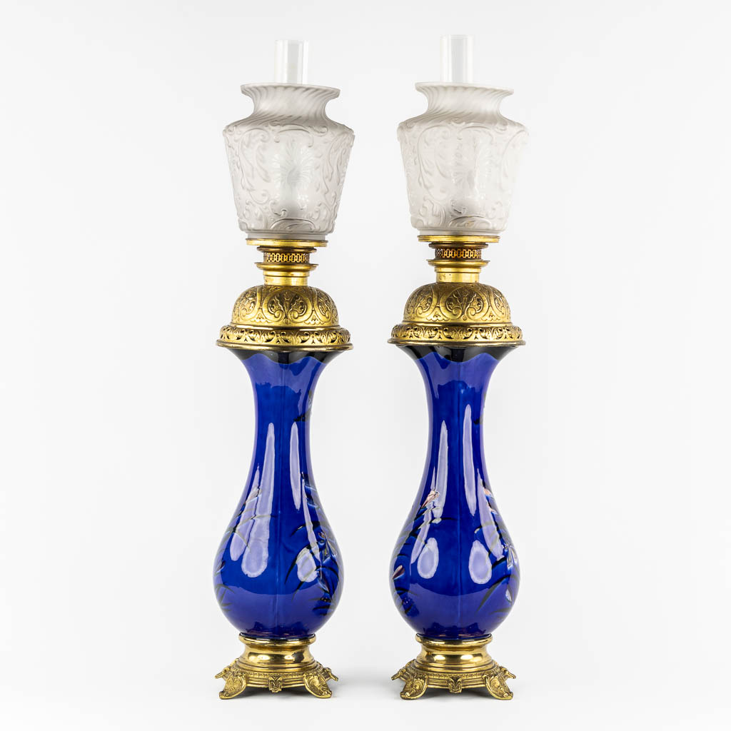 A pair of large oil lamps, porcelain and brass. Circa 1900. 