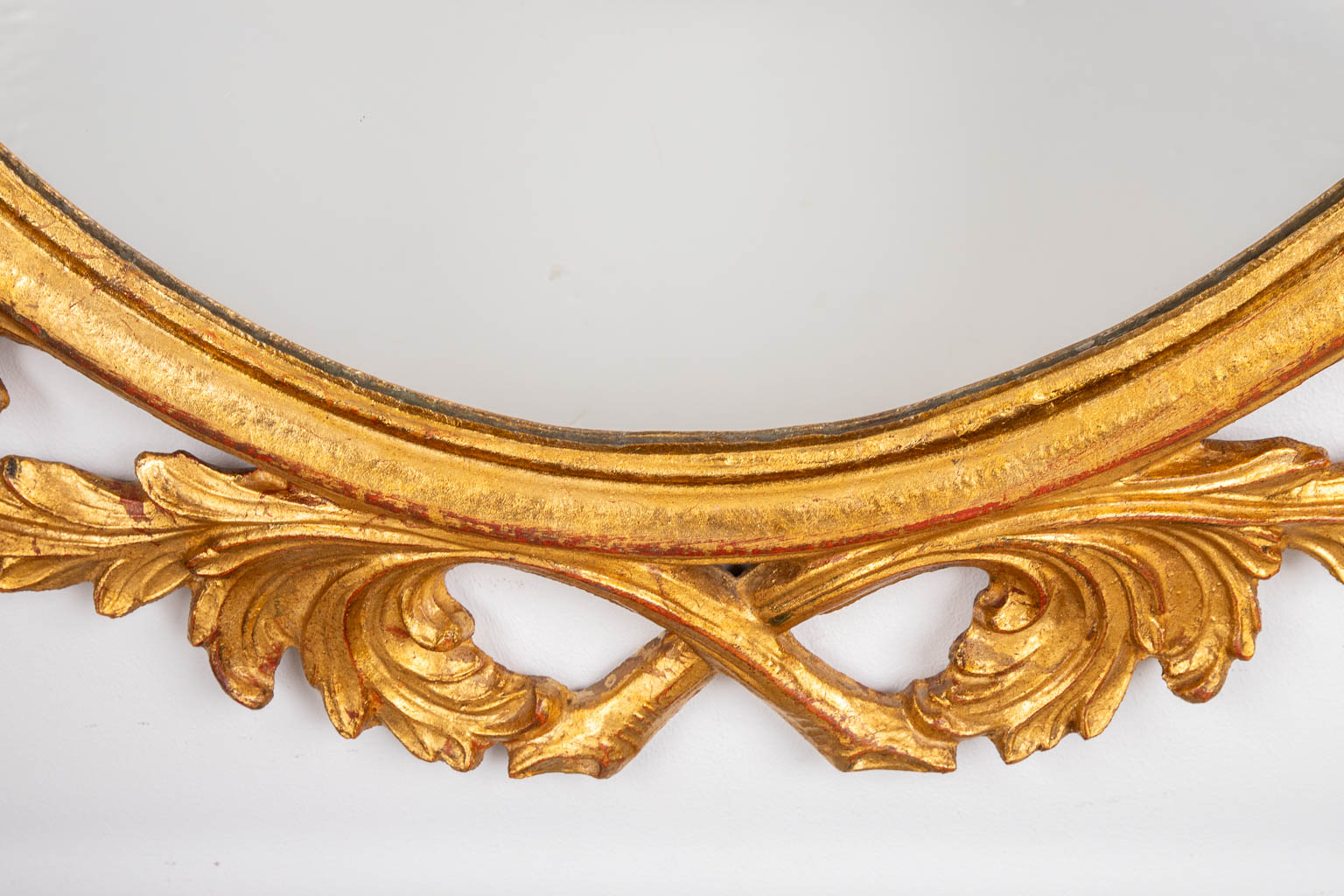 A wood-sculptured oval mirror, circa 1960. (W:73 x H:94 cm)