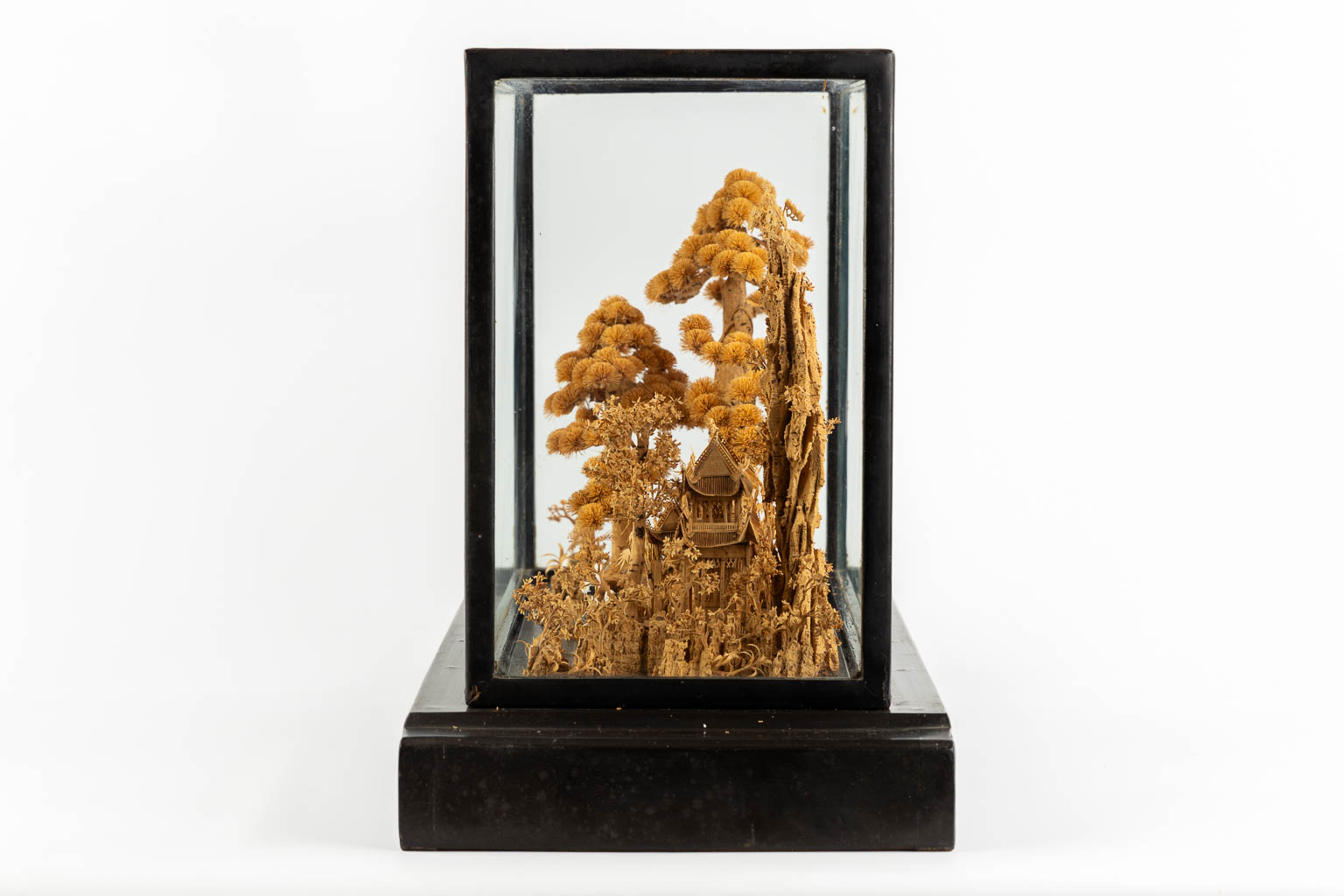 A Japanese cork diorama of a garden, in a glass display cabinet. 20th C. (L:25 x W:55 x H:36 cm)