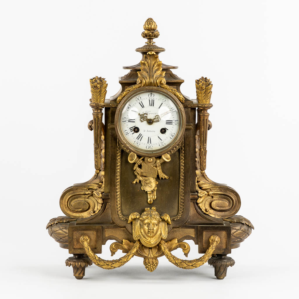 A mantle clock, gilt bronze in a Louis XVI style. Circa 1900. (L:16 x W:32 x H:41 cm)