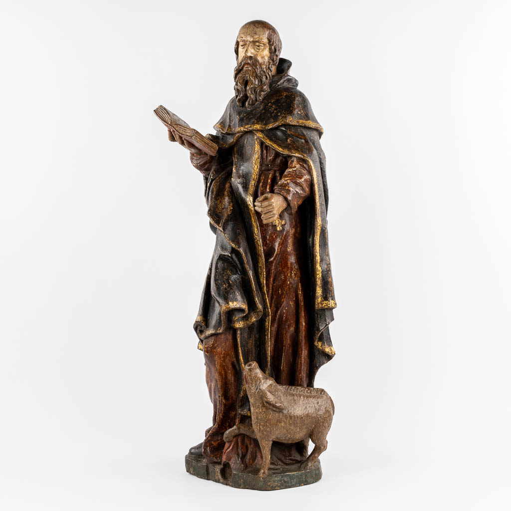 An antique wood-sculptured figurine of Saint Anthony the Great, with a pig. 18th C.