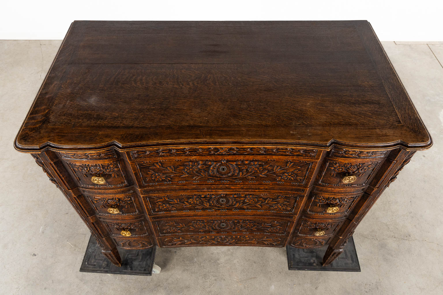 A three-drawer commode, floral wood-sculptures in a Louis XVI style. (L:60 x W:110 x H:99 cm)