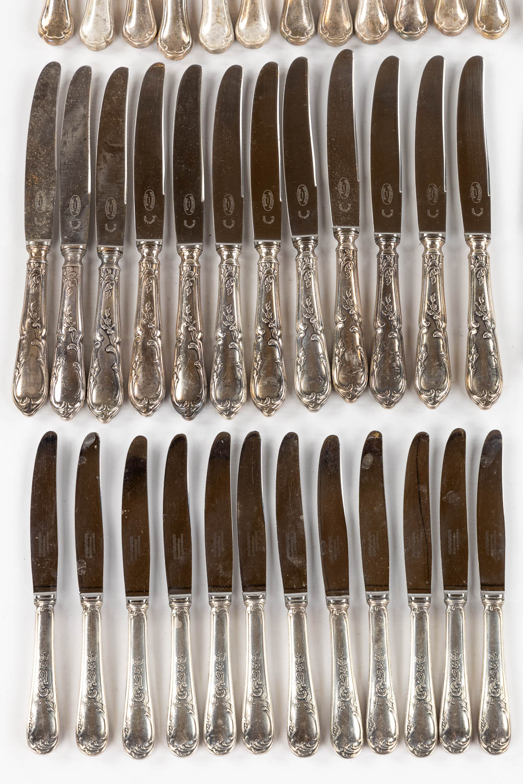 Twelve sets of twelve silver-plated knives. 