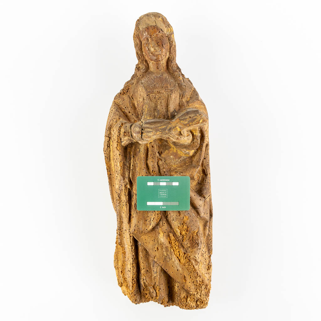 An antique wood-sculptured figurine of a saint holding a book, oak, 17th C. (L:17 x W:20 x H:53 cm)