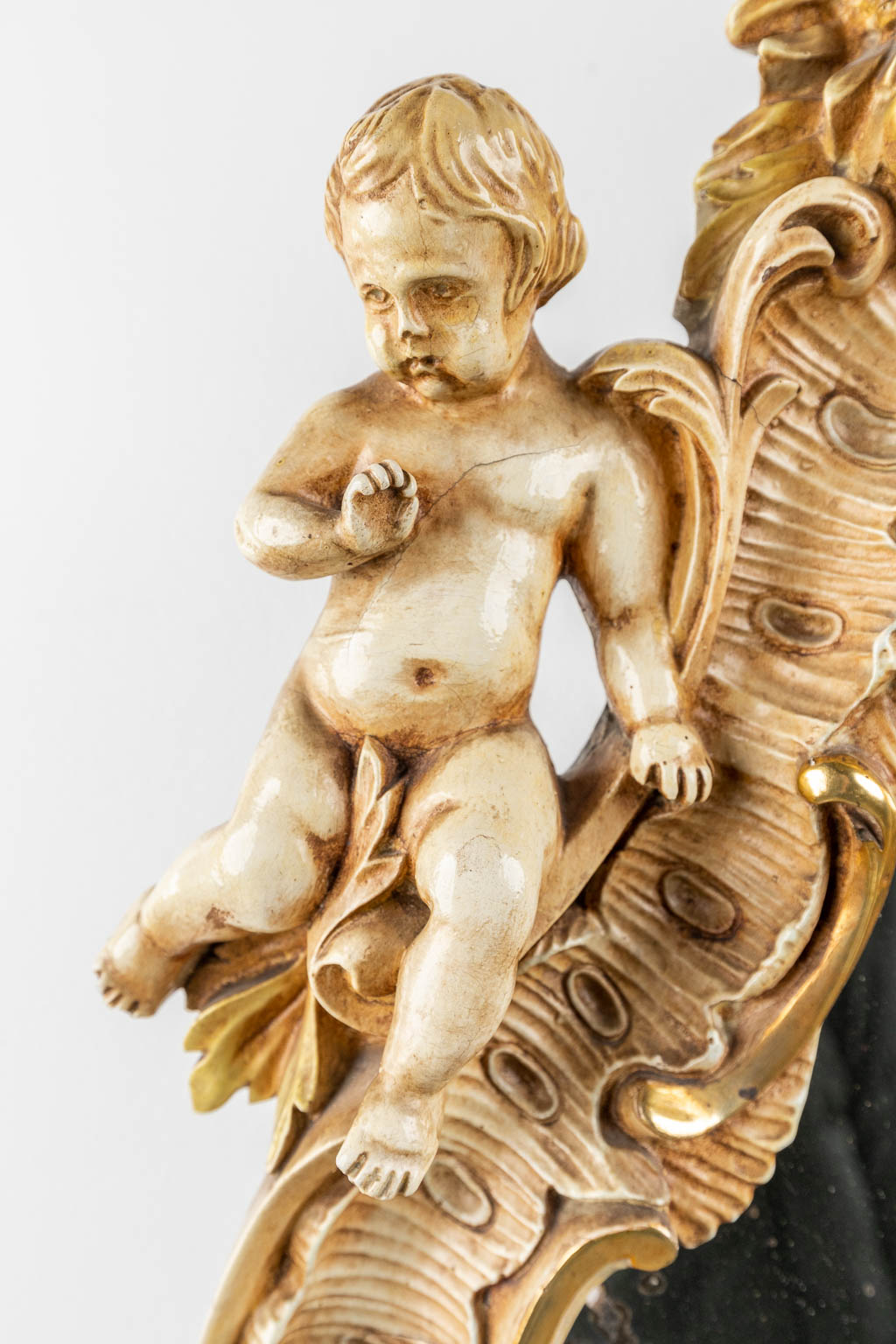 An antique mirror with musical putti. 1886. (W: 60 x H: 97 cm)