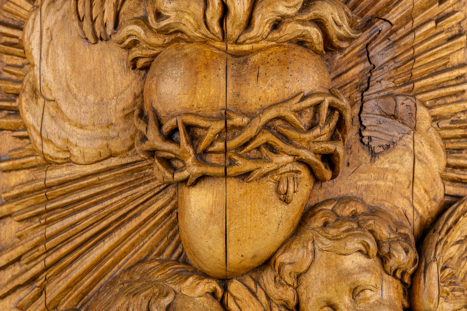 A wood-sculptured tabernacle door, Angels and a Sacred Heart, Baroque style. 