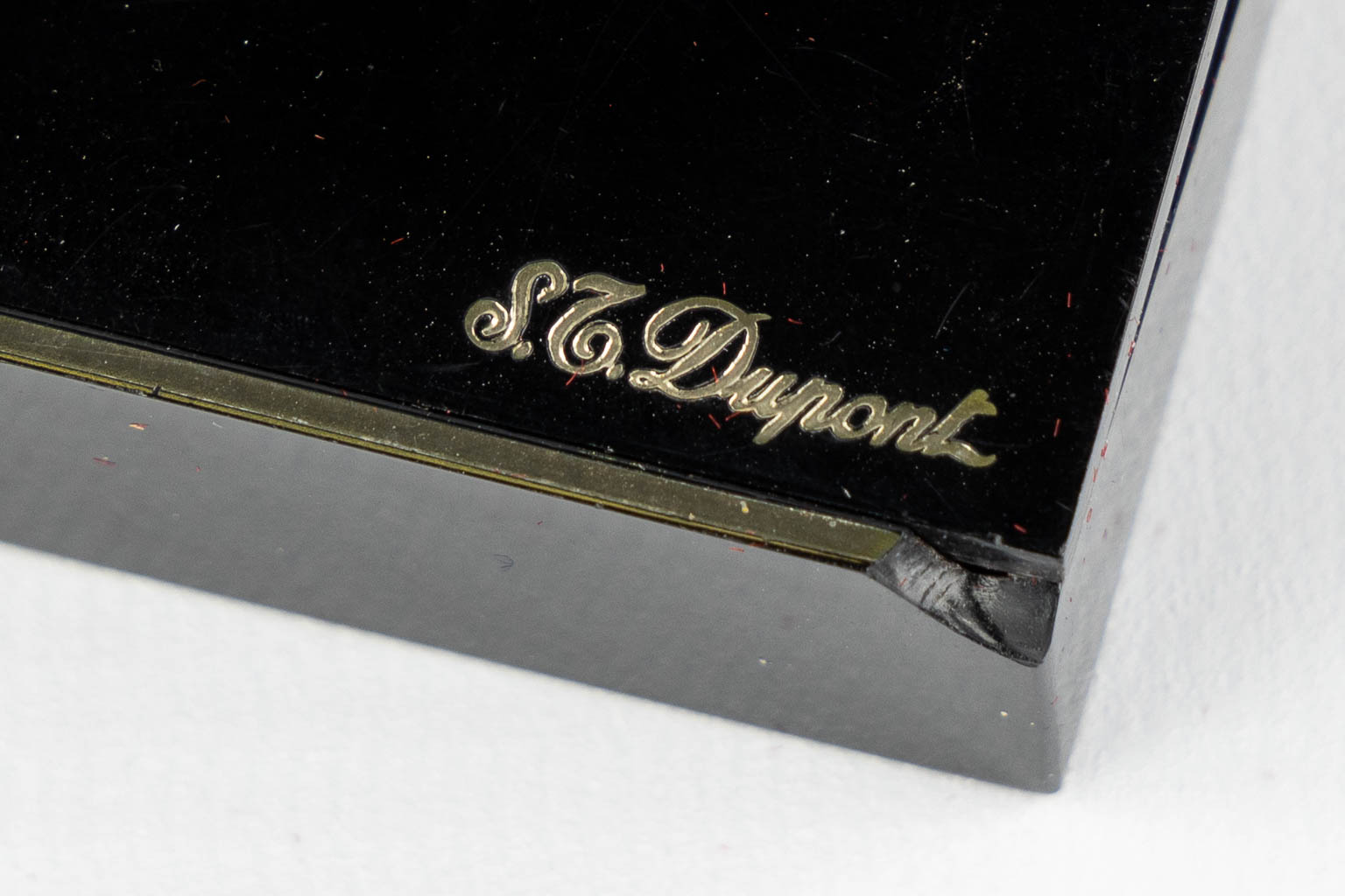 ST. Dupont, Three gold and silver plated lighters, added a Givency lighter. (L:1 x W:3,5 x H:6 cm)