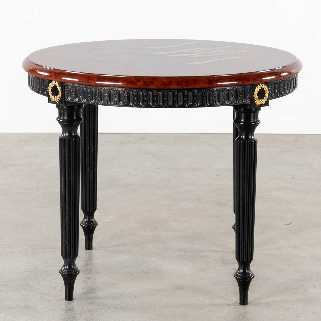 A decorative table with 'Cranes' decor, on a Louis XVI style table base.