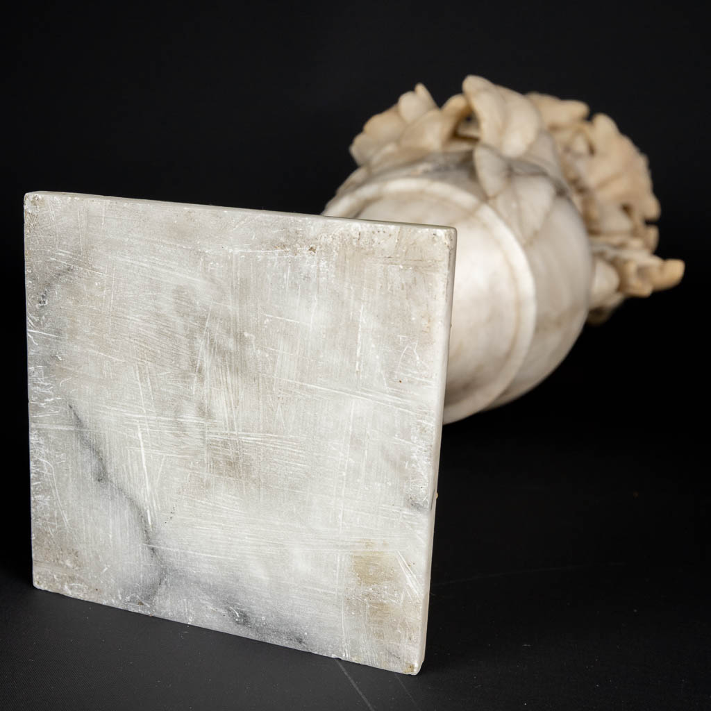 A three piece mantle garniture set, sculptured alabaster. (H:45 x D:15 cm)