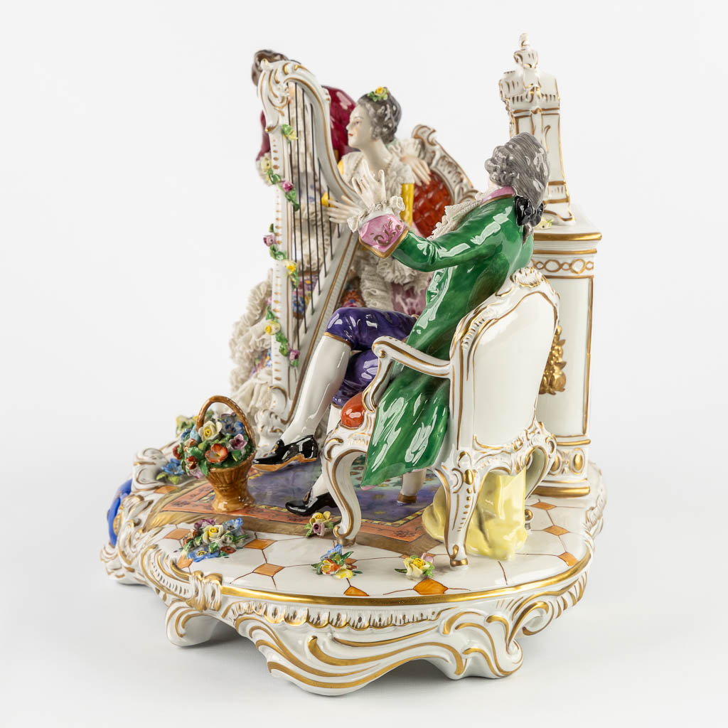 Volkstedt Rudolstadt, a large group 'Playing the harp' polychrome porcelain. 